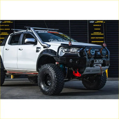 Black and silver steel rockarmor gt hoop bullbar with rugged tires roof rack on ford ranger wildtrak 4wd ute offroad