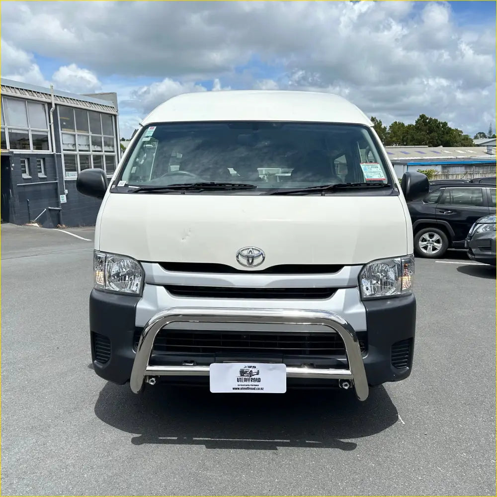 White toyota hiace van with chrome bull bar and black front bumper showing off bash plates underbody protection