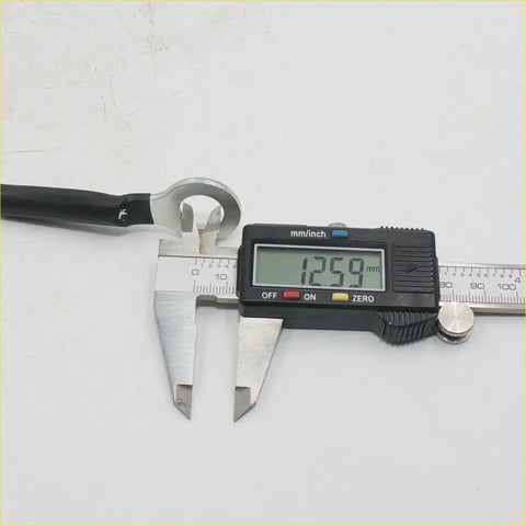Black-handled wrench with silver metal head measured at 12.59 mm for 18 inch tail gate cables nissan titan