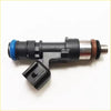 Black plastic fuel injector for ford courier 4.0l petrol with blue o-ring and silver tip plus detached black cap nearby