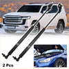 Black metal gas struts for toyota 80 series front bonnet with white suv and blue sedan in the background