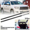 Black metal gas struts for rear hatch lift supports shown from back with white toyota sequoia suv in background