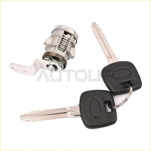 Silver metal tailgate back door lock cylinder with two black plastic key fobs for toyota tundra