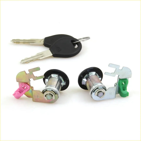 Two chrome door lock cylinders with pink and green plastic parts and black key fobs for nissan datsun 720/navara d21