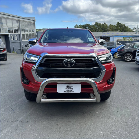 Red toyota hilux pickup with a 304 stainless steel chrome nudge bar bumper guard fits 2021-2025 models