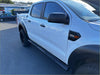 White ford ranger pickup with black stainless steel 4 inch oval running board and rugged tires shown from the back side