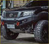 Black nissan np300 pickup truck with rugged black aftermarket grill navara nismo and off-road tires in front view