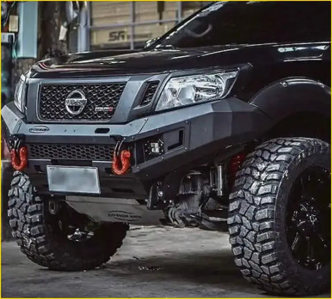 Black nissan np300 pickup truck with rugged black aftermarket grill navara nismo and off-road tires in front view