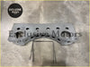 Gray metallic alloy tank mounting bracket engine block with multiple holes and curved design visible from back side