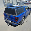 Blue ford ranger xlt pickup truck with black aluminium hard-shell tonneau cover rear view for 2022+ new ranger