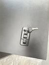 Silver metallic combination lock with key inserted on aluminium canopy carport cover for nissan navara 2015-2025 double cab