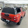 Red toyota hilux with black aluminium canopy and roof rack shown from the back for 2015-2025 sr5 models