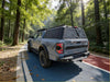 Gray metallic ford ranger raptor pickup with black roof rack showing aluminium canopy with rear view glass back side