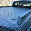 Gray diamond plate aluminium hard lid truck bed cover with sleek rugged design and embossed branding for mazda bt-50 double cab back side