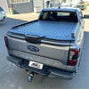 Gray ford ranger xlt pickup with black diamond plate aluminium hard lid tonneau cover shown from backside