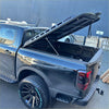 Black aluminium heavy-duty hard lid with sleek reinforced design and support struts for toyota hilux 2015-2021 back view
