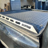 Silver aluminium heavy-duty hard lid with diamond-patterned metal and black trim for toyota hilux 2015-2021+