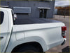 Black aluminium tri fold hardlid tonneau cover on white triton 2015 plus pickup truck back side view