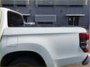 Black aluminium tri fold hardlid tonneau cover fitted over the bed of a white triton 2015+ pickup truck