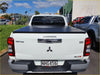 White mitsubishi triton glx-r pickup with black aluminium tri fold hardlid tonneau cover shown from the back side