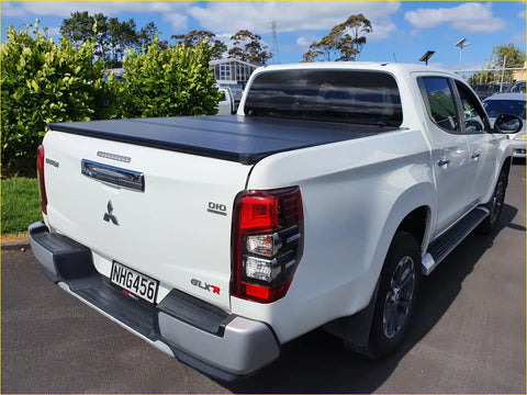 Back view of white mitsubishi triton glx-r with black aluminium tri fold hardlid tonneau cover 2015+
