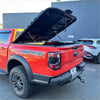 Red ford ranger raptor with black aluminum hard lid tonneau cover on the back side for ford ranger 2022+ new ranger