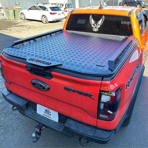 Black diamond plate aluminum hard lid tonneau cover with utebrroad branding on the back for ford ranger 2022+