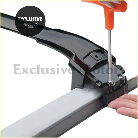 Black plastic roof rack mounting bracket with silver metal hardware being tightened with orange screwdriver on mazda cx-5 aluminum cross bars