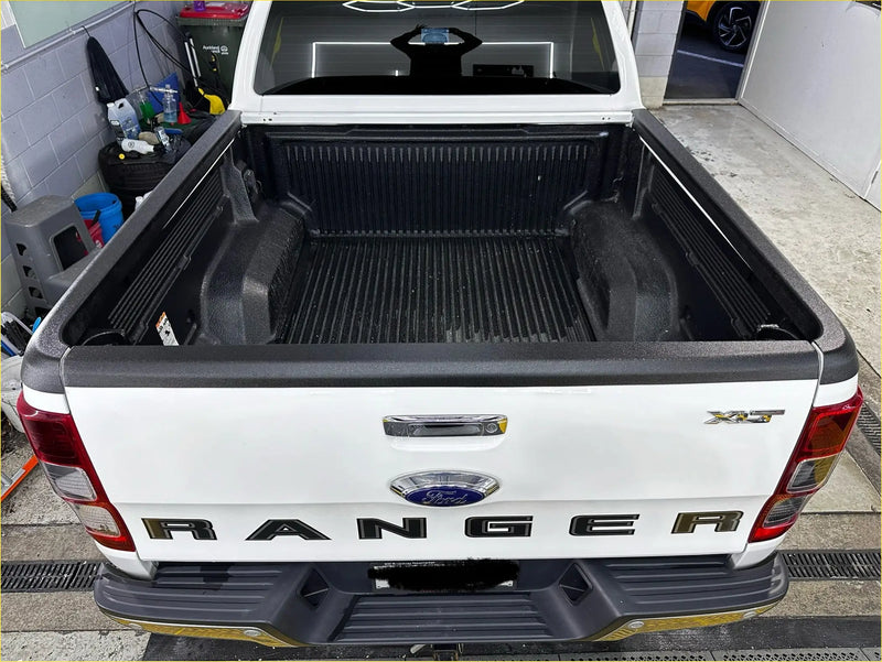 White ford ranger xlt with black bed liner and chrome accents showing bedside rail covers 3 piece set rear view