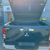 Black mitsubishi triton 2024+ bedside rail covers 3 piece set shown from back with lifted tailgate and open bed