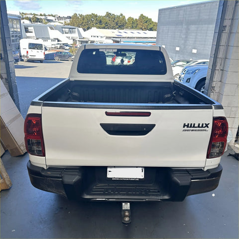 Back side of a white toyota hilux pickup truck showing black textured bedside rail covers 3 piece set 2015-2020