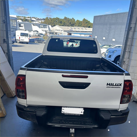 White toyota hilux pickup with black textured bedside rail covers 3 piece set 2015-2020 shown from the back side