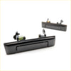 Black plastic door handle set for Toyota Hilux 1983-1997 with integrated spring mechanism and mounting hardware visible from back