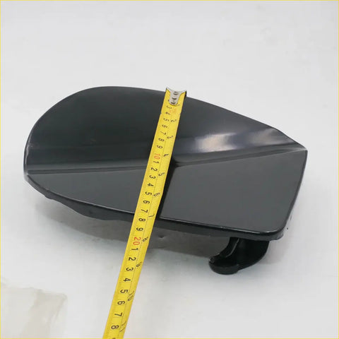 Black glossy plastic fuel door cover with smooth curved design and latch for Nissan Frontier Navara King Cab D40 4x4