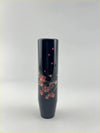 A sleek dark navy ceramic blossom gear knob decorated with pink cherry blossoms and red heart motifs
