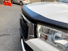 Black rubber bonnet guard matte finish with rivets mounted on white monsoon toyota hilux 2015-2020