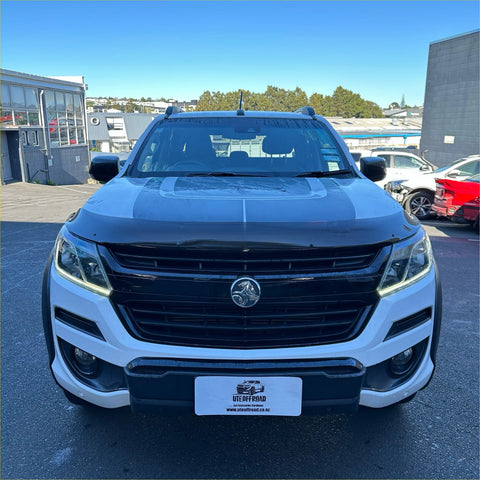 White and black two-tone holden colorado pickup with bold grille and bonnet guard protector stone guard for tough use