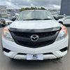 White mazda bt-50 pickup with black front grille and chrome emblem featuring bonnet guard protector stone guard