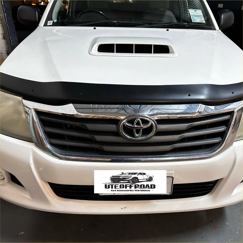 Black plastic bonnet guard protector with integrated vent matte black on white toyota hilux 2012-2015
