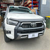 White toyota hilux 2021 with matte black bonnet guard protector stone guard and black front bumper guard and snorkel