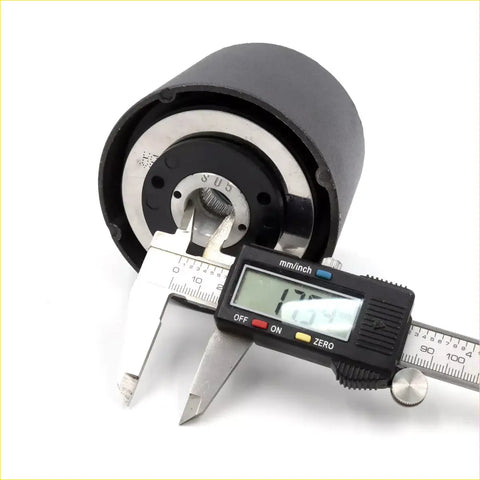 Black cylindrical boss kit steering wheel hub adapter with silver metal parts measured by digital caliper for toyota hilux