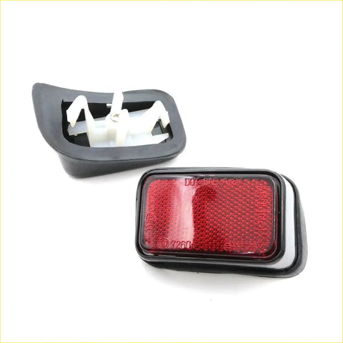 Black plastic rectangular trailer tail light with red reflector and white mount for toyota hilux 1997-2005 backside view