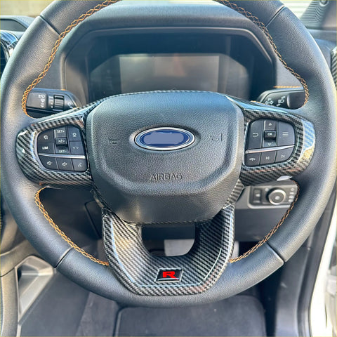 Black leather steering wheel with carbon fiber trim and orange stitching for ford ranger 2022 plus with r badge
