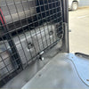 Black metal grid cargo barrier mounted inside a toyota hiace 2005-2019 narrow body vehicle, rear view