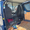 Black metal dog crate cage installed inside van showing back side as cargo barrier for toyota hiace 2005-2019 narrow body