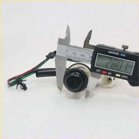 Black plastic push button cigarette lighter switch with wires and diameter measured by digital caliper for toyota hilux