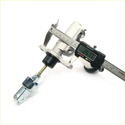 Silver metallic clutch master cylinder with black rubber boot and brass fittings measured by digital caliper for toyota hilux