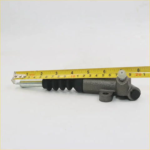 Gray metallic clutch slave cylinder for Mazda B-Series with black rubber boot and silver piston rod 20.1 inches long