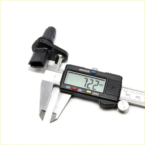 Black plastic crankshaft position sensor for nissan dualis qashqai j10 2006-2013 being measured with digital caliper