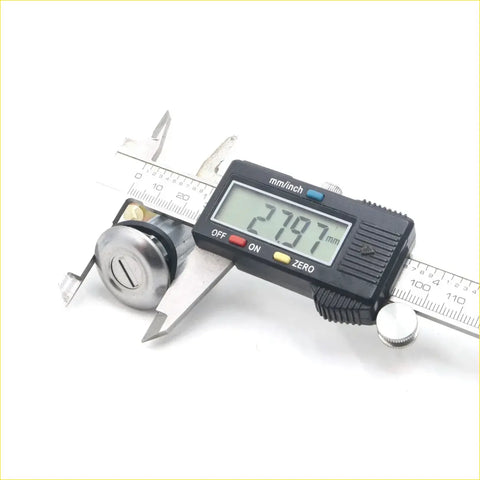 A shiny chrome cylinder door lock x2 for toyota hilux 1983-1997 being measured with a digital caliper